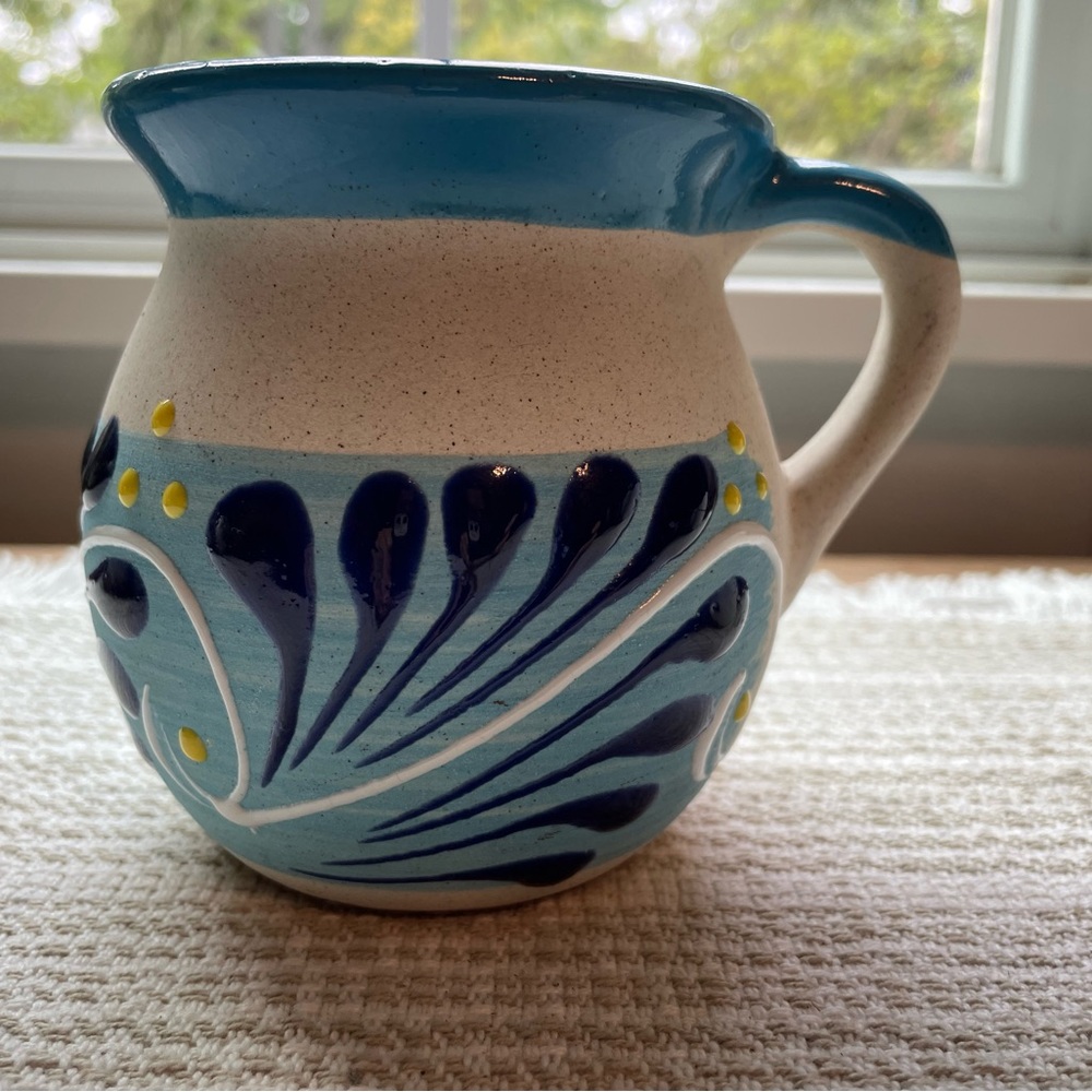Mexican handmade red pottery with blue and yellow paint coffee mug.